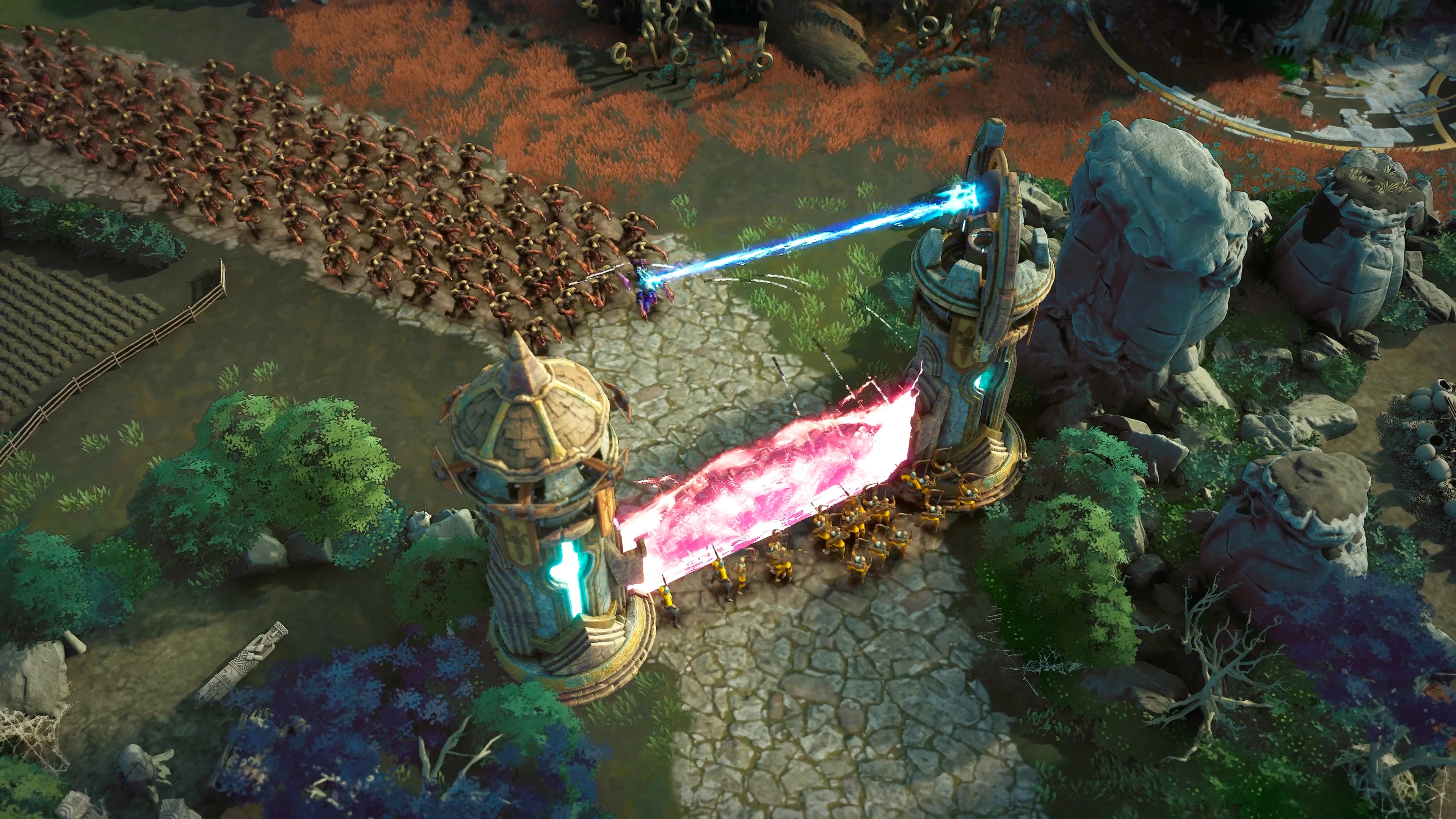 Eversiege large-scale siege battle with magical towers defending a fortress against enemy waves.